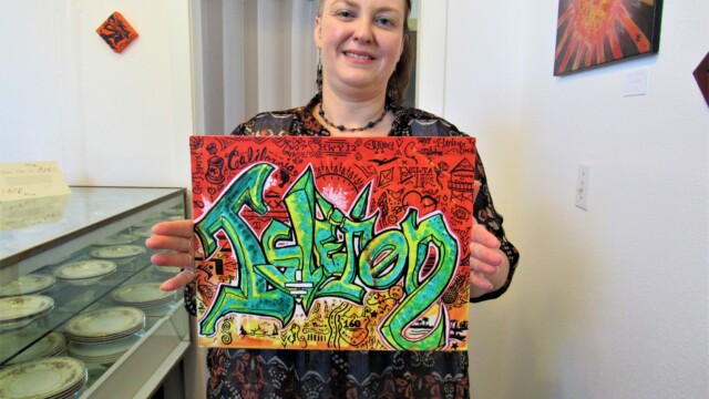 Zahna holds an Isleton-centric graphic by Harley.